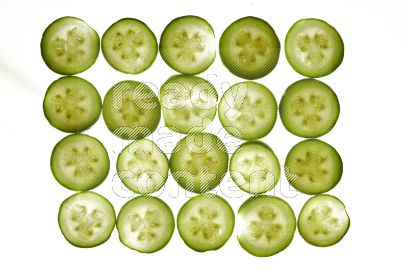 Zucchini slices on illuminated white background