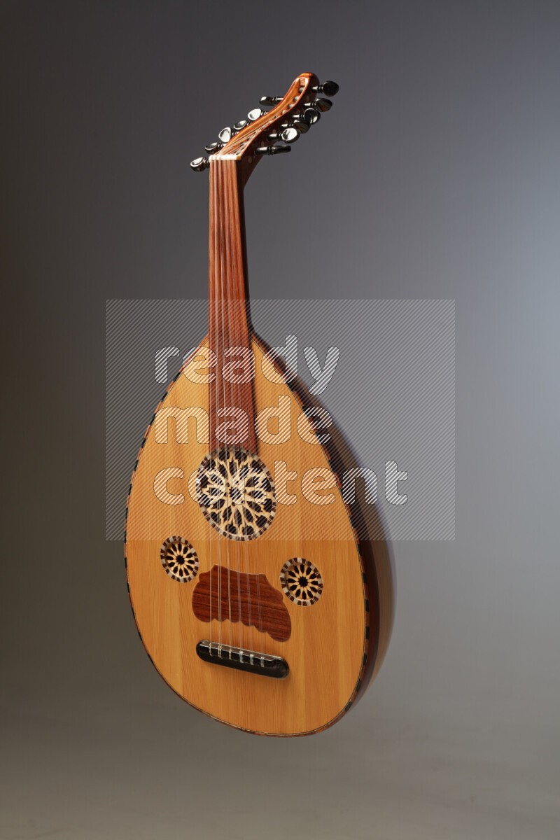 a wooden brown Oud on a gray background