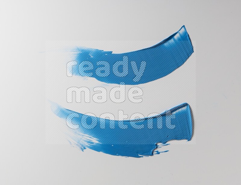 Blue curved painting knife strokes on white background