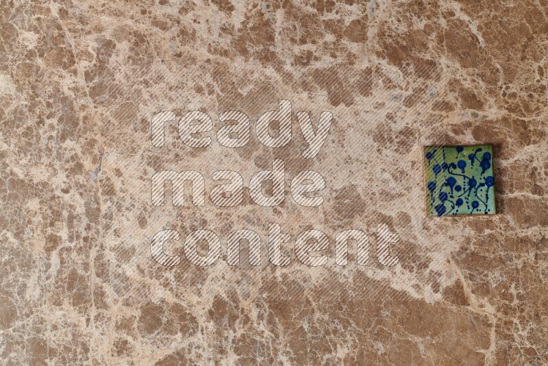 A decorative coaster on beige marble background