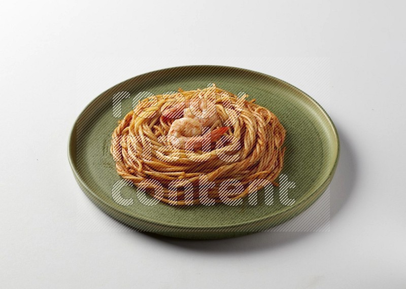 spaghetti pasta with red sauce on a green plate on a white background