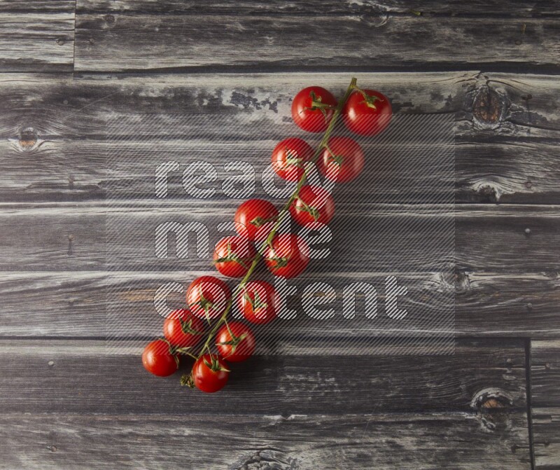 Single cherry tomato vein topview on a grey wooden background