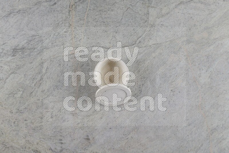 A multicolored pottery Cup on grey marble background