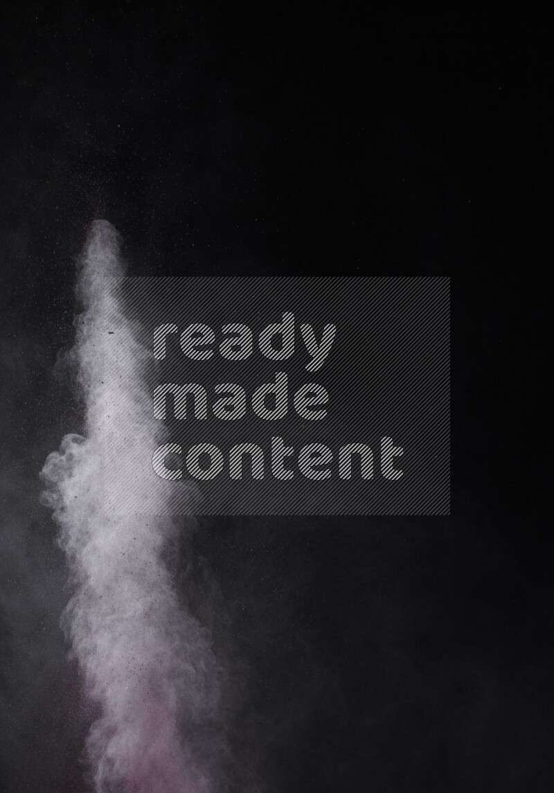 A side view of red powder explosion on black background