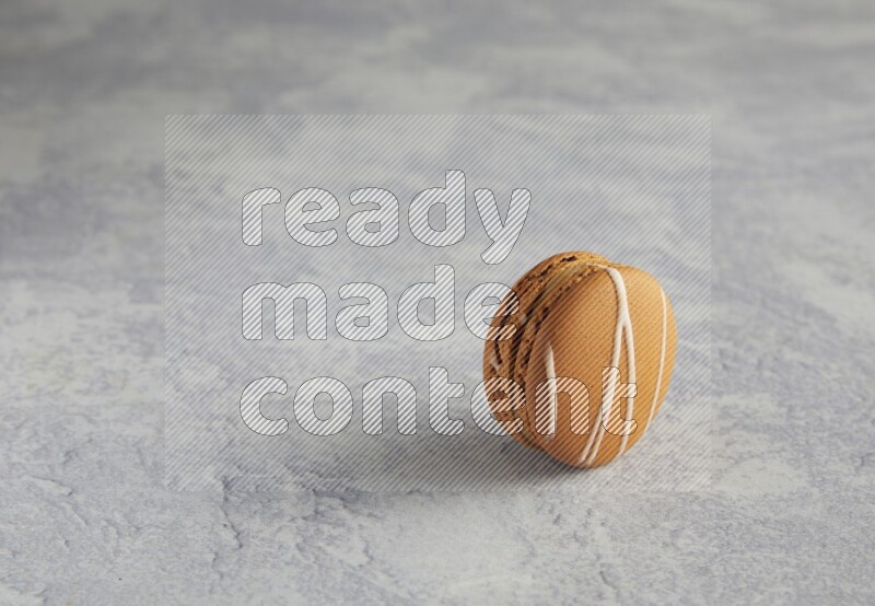 45º Shot of Brown Irish Cream macaron on white marble background