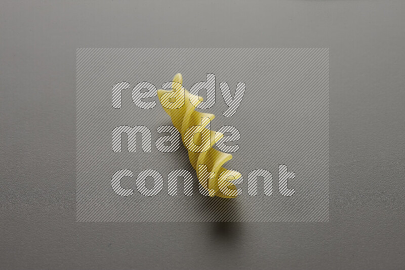 Fusilli pasta on grey background