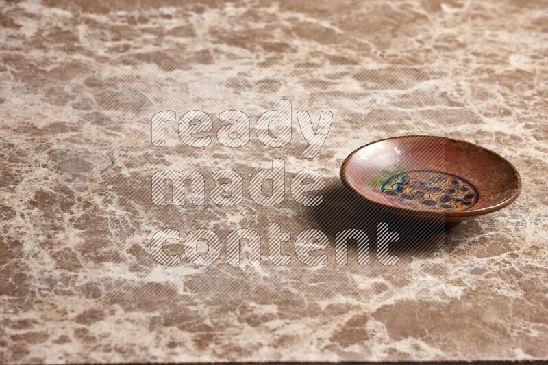 Decorative Pottery Plate on Beige Marble Flooring