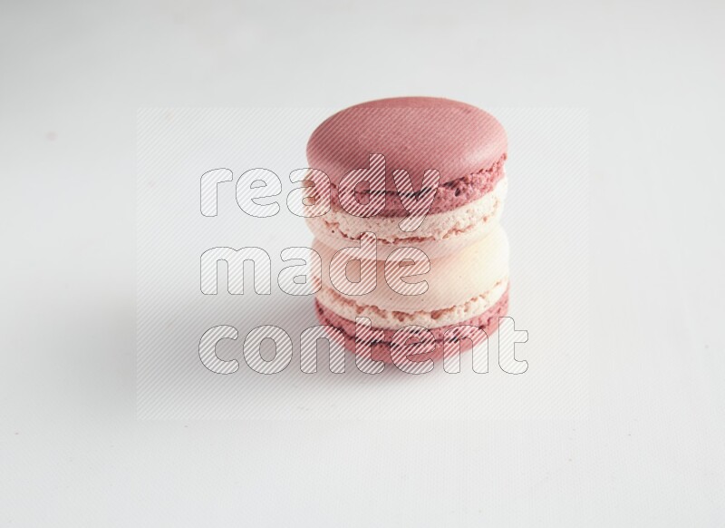 45º Shot of two Pink Litchi Raspberry macarons on white background