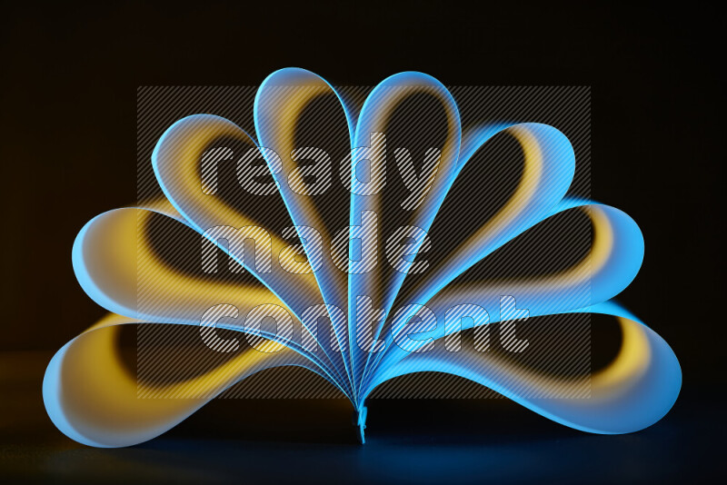 An abstract art piece displaying smooth curves in yellow and blue gradients created by colored light