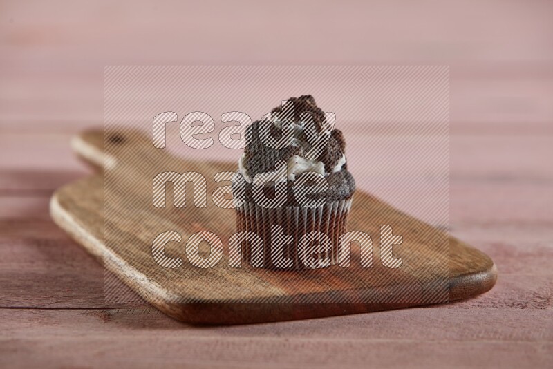 Chocolate mini cupcake topped with oreo on a wooden board