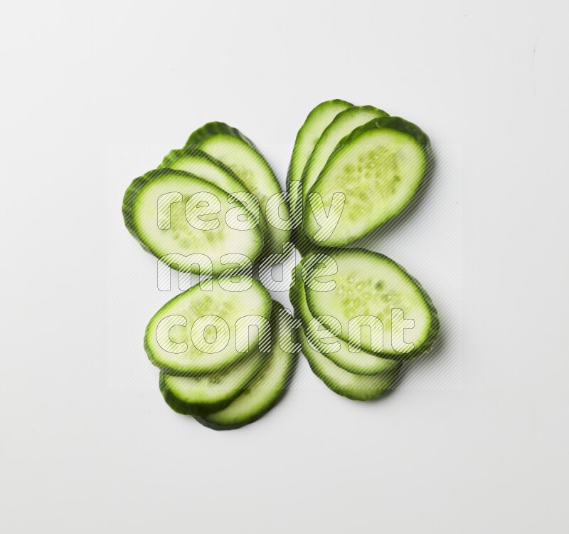 Multiple cucumber slices on white background