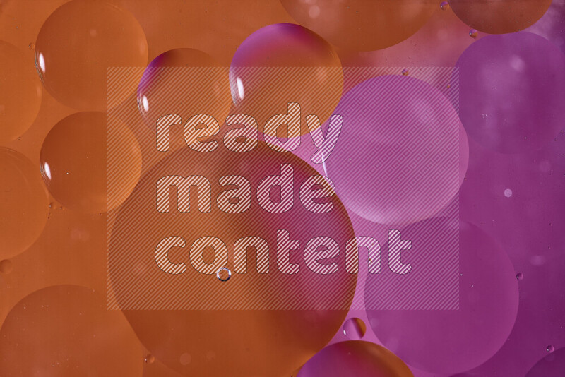 Close-ups of abstract oil bubbles on water surface in shades of orange and pink