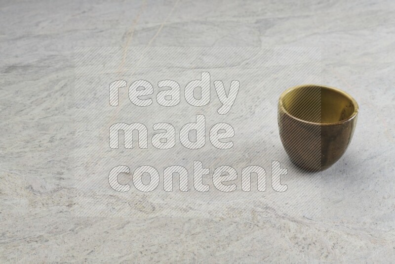 A multicolored pottery bowl on grey marble background