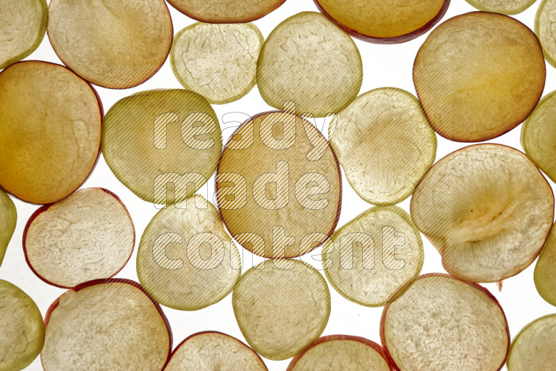 Plum slices on illuminated white background