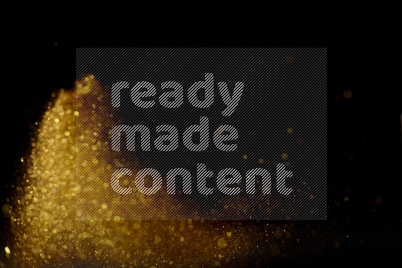 Gold glitter powder isolated on black background