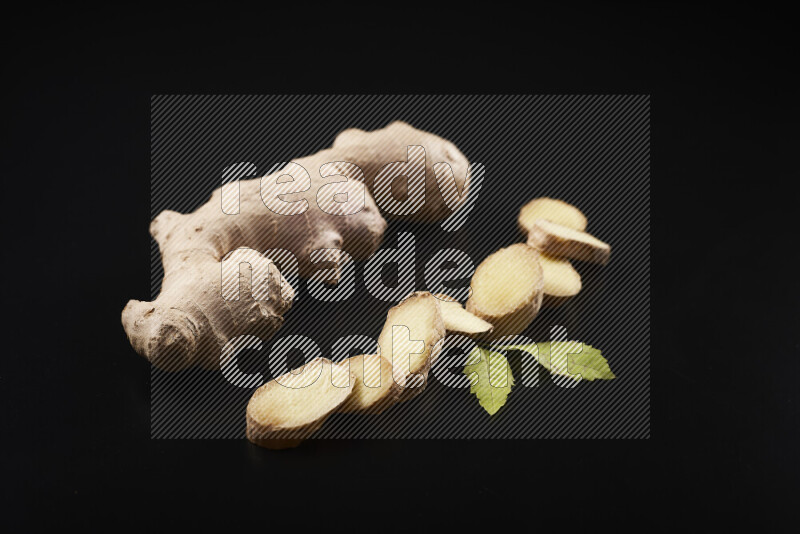 Fresh ginger root on black background