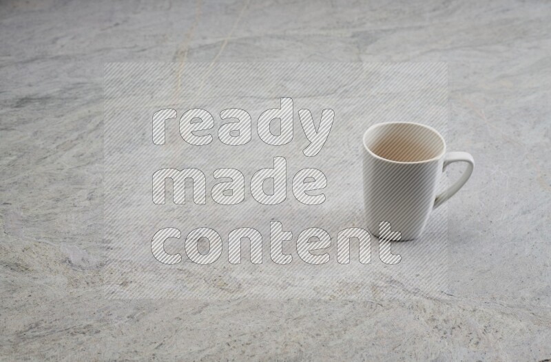 A white ceramic mug on grey marble background