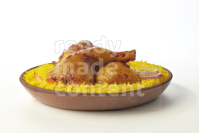 yellow basmati Rice with kabsa chicken pieces on a pottery plate direct on white background