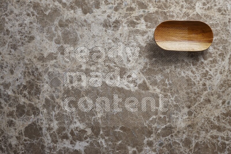 A wooden plate on beige marble background