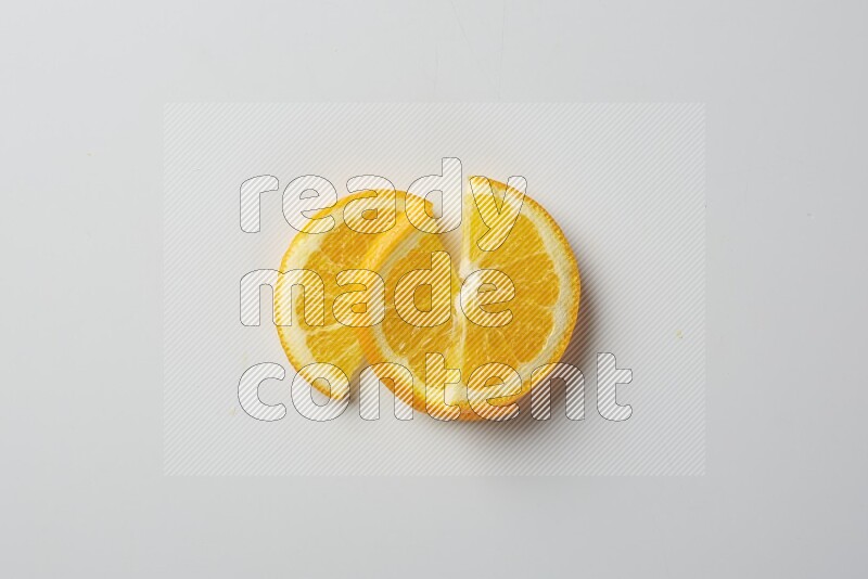 Three halves of an orange slices on white background