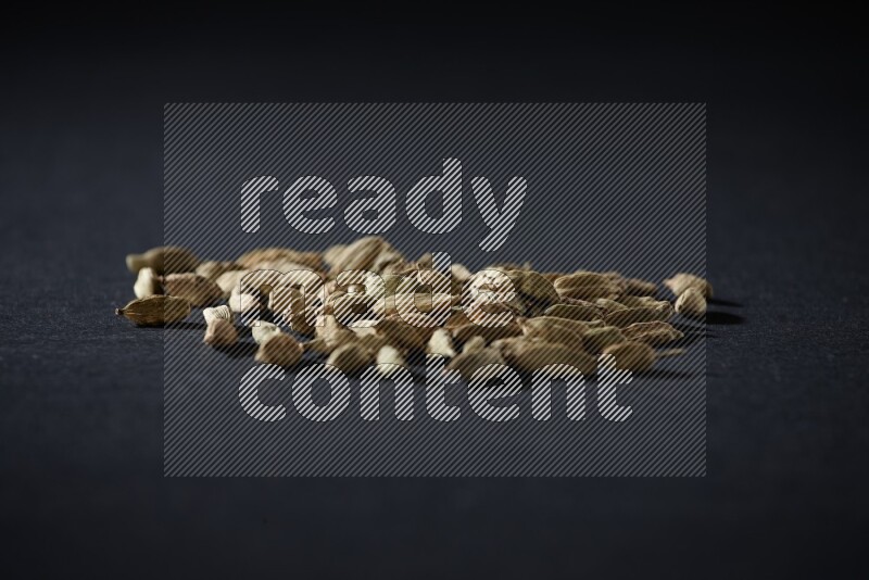 Cardamom seeds on black flooring