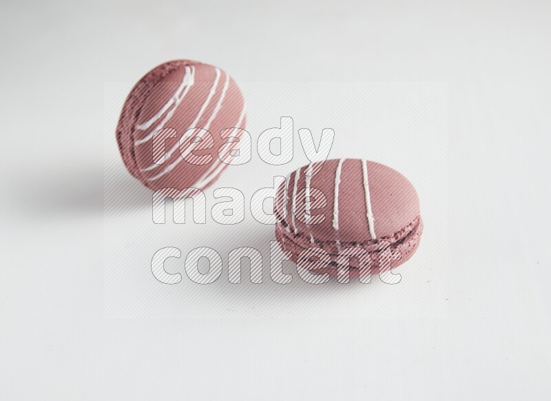 45º Shot of two Red Poppy Flower macarons on white background