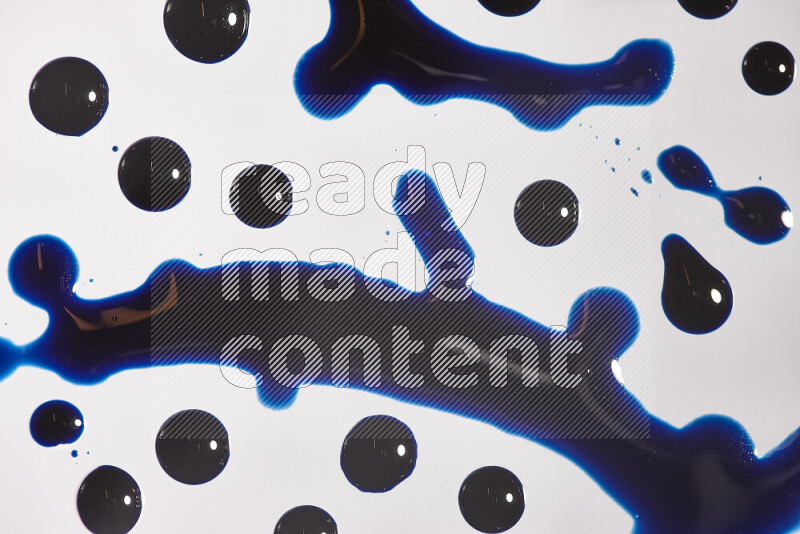 Close-ups of abstract blue paint droplets on the surface