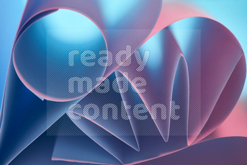 An artistic display of paper folds creating a harmonious blend of geometric shapes, highlighted by soft lighting in blue and pink tones
