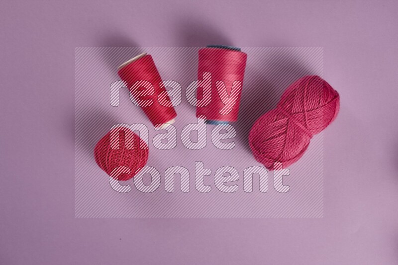 A pink and purple collection of sewing and tailoring tools arranged on a purple background