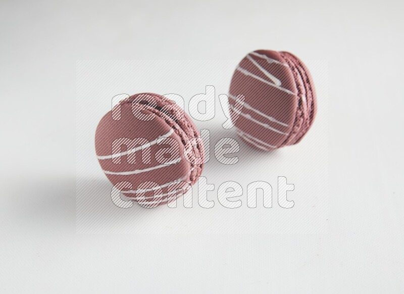 45º Shot of two Red Poppy Flower macarons on white background