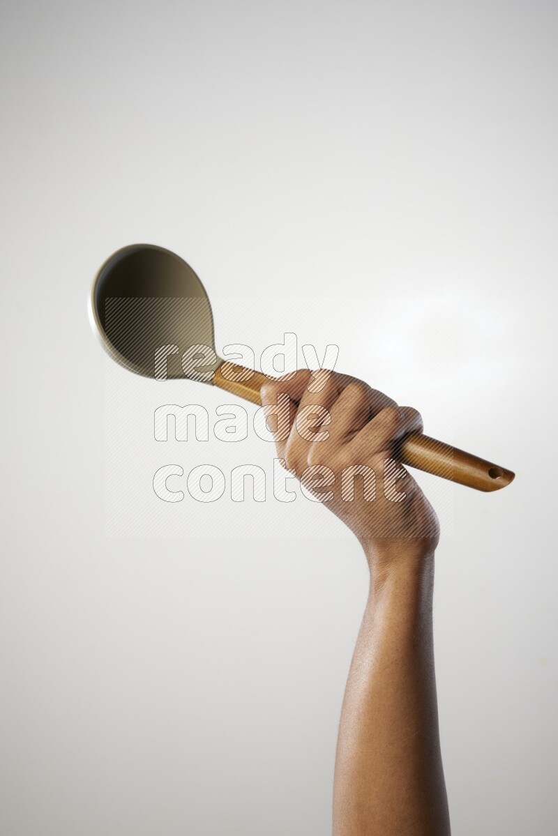 Male Hand Holding ladle on white background