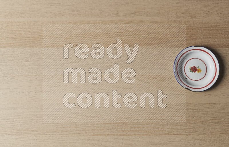 A vintage metal plate on light wooden background