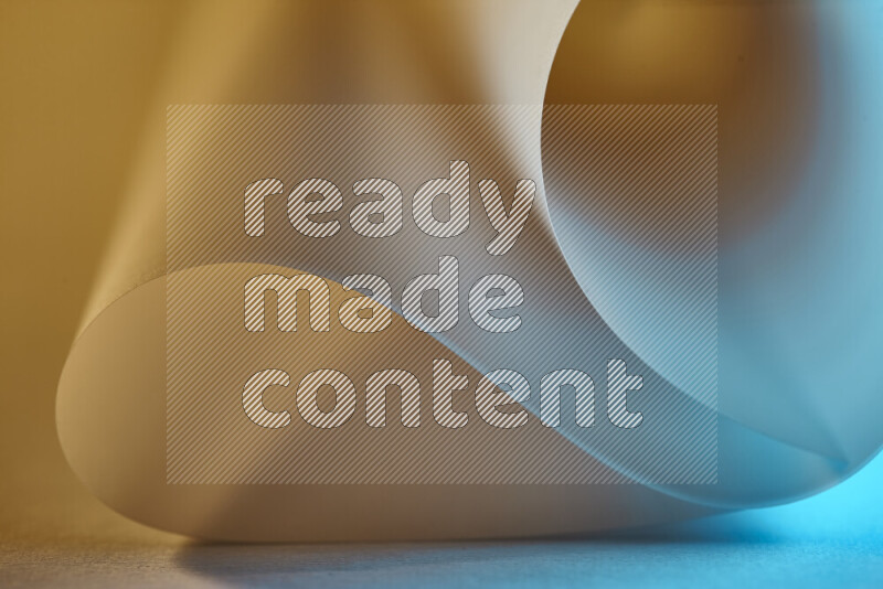 An abstract art piece displaying smooth curves in blue and gold gradients created by colored light