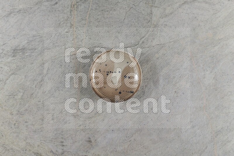 A multicolored pottery Bowl on grey marble background