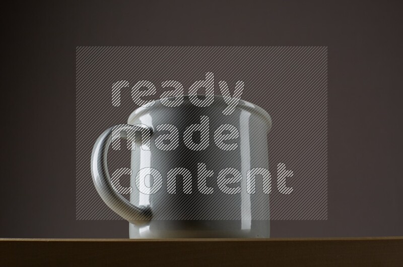 Low angle shot of a grey cup on grey background
