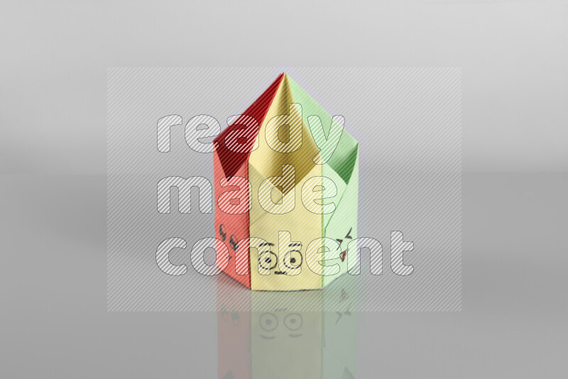 Origami pen holder on grey background