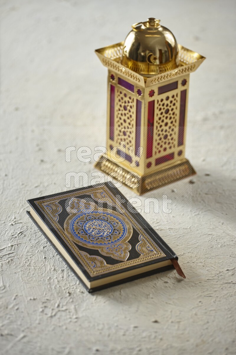 A golden lantern with different drinks, dates, nuts, prayer beads and quran on textured white background