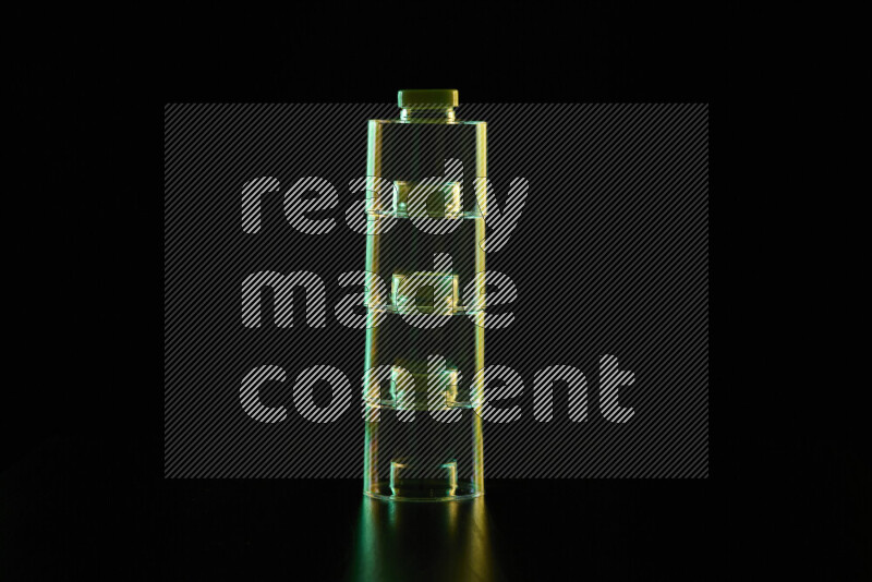 Glassware with rim light in green and yellow against black background