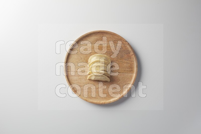Five Sambosas on a wooden round plate on a white background