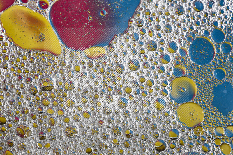 Close-ups of abstract soap bubbles and water droplets on multicolored background