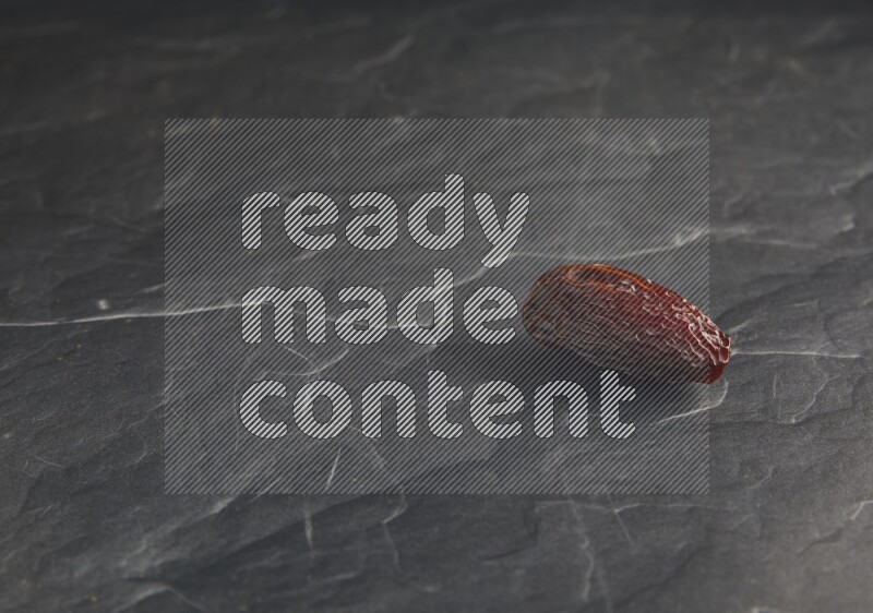 one madjoul date on a black textured background