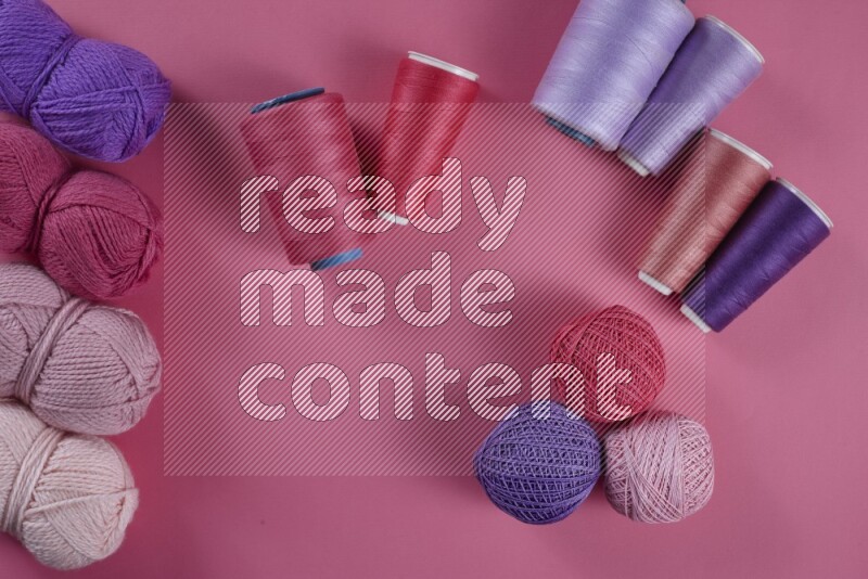 A purple and pink collection of sewing and tailoring tools arranged on a pink background