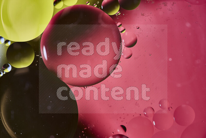 Close-ups of abstract oil bubbles on water surface in shades of yellow and pink
