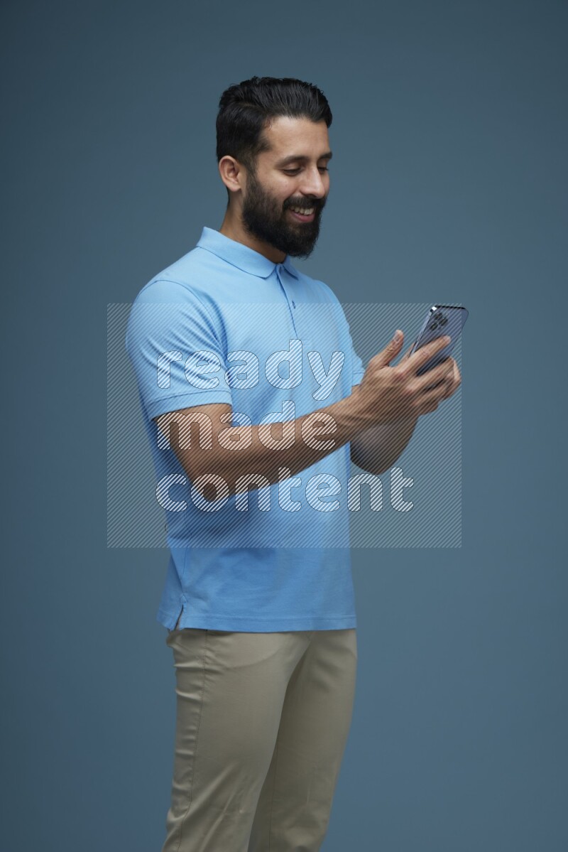 A man Swiping in a blue background wearing a Blue shirt