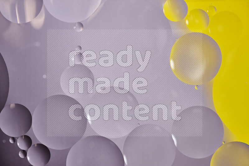 Close-ups of abstract oil bubbles on water surface in shades of white and yellow