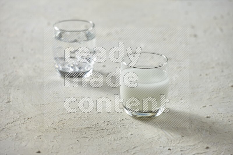 Cold drinks in a glass cup such as water, tamarind, qamar eldin, sobia, milk and hibiscus on textured white background