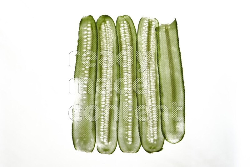 Cucumber slices on illuminated white background