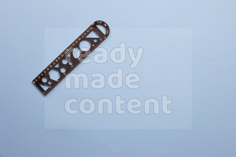 A wooden ruler on blue background