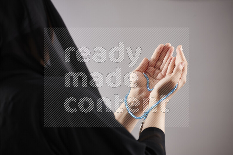Woman hands holding praying beads (sebha) in different positions