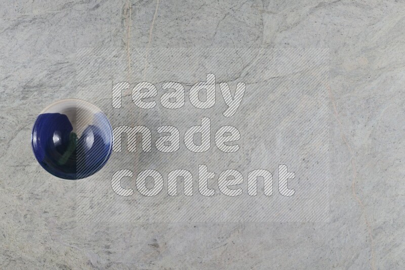 A multicolored pottery Bowl on grey marble background